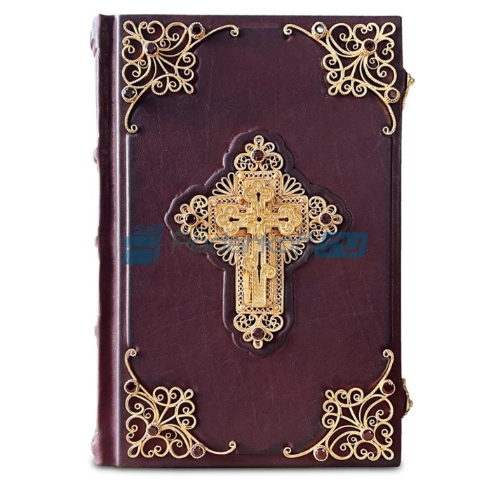 Книга в кожаной обложке с золотой филигранью Библия
